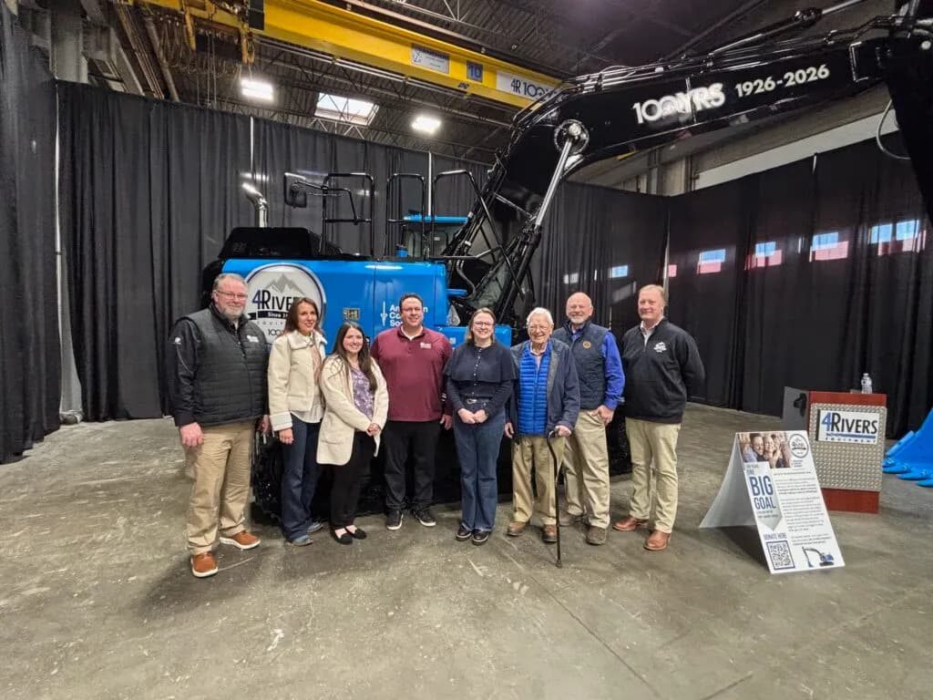 4RE | 4Rivers and American Cancer Society personnel in front of the blue Centennial Excavator.