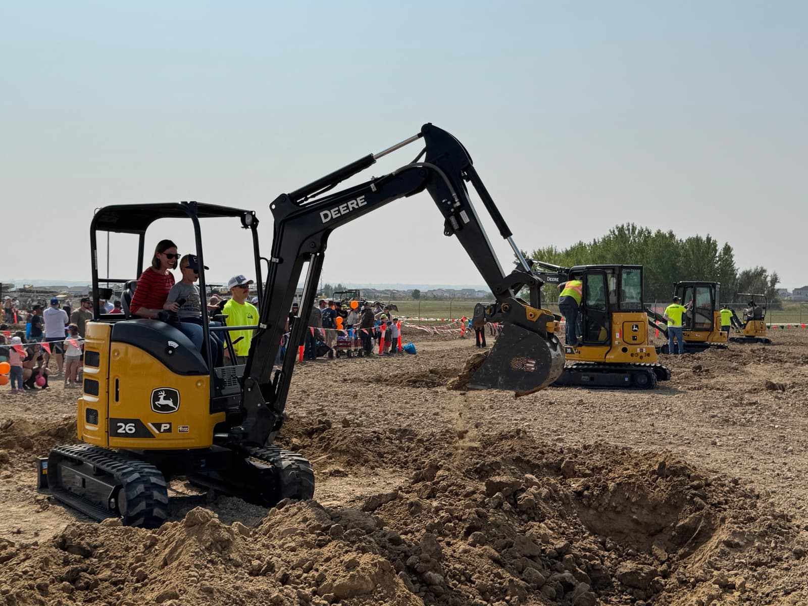 4RE | A mom with her son operating a mini excavator at Big Dig Colorado 2025.