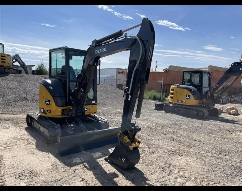 4RE | A John Deere mini excavator on a job site.
