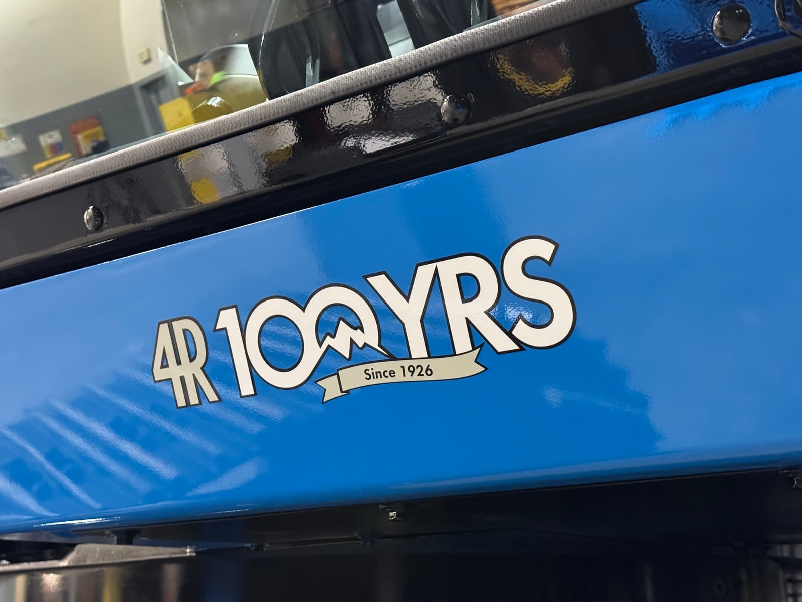 Decal on the back of our "Big Blue" anniversary edition excavator; text reads "4R 100 YRS Since…
